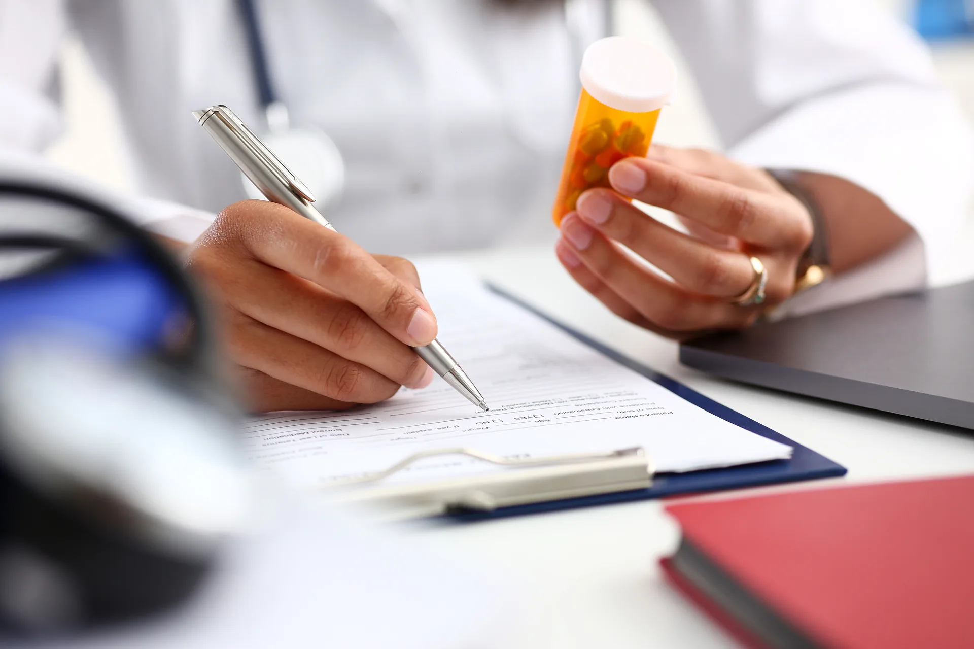 Doctor or pharmacist prescribing registered medicine and recording adverse drug reactions